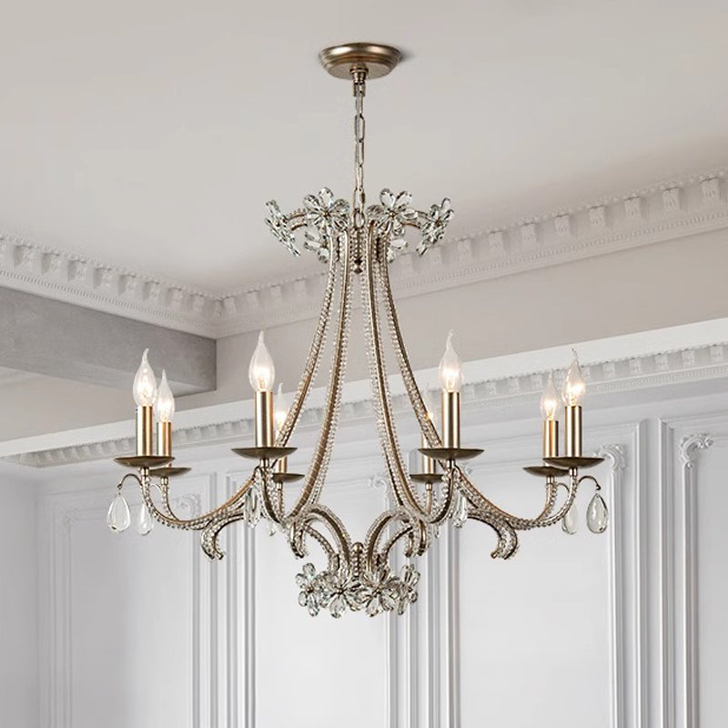A stylish chandelier with five lights and crystal details, providing a touch of luxury and brightness to the environment.