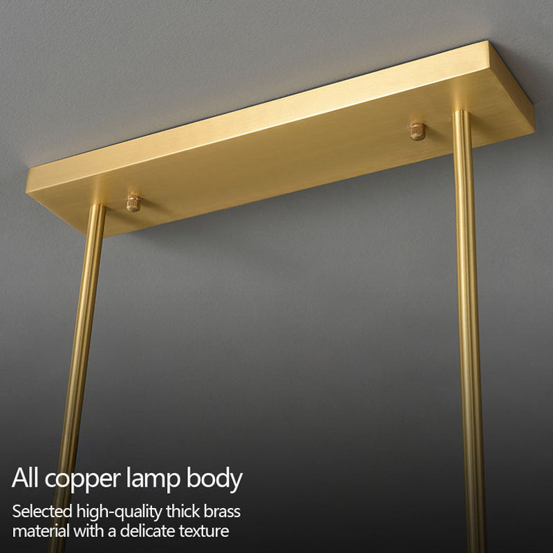 Close-up view of a chandelier's canopy and suspension rods, crafted from high-quality thick brass with a polished, delicate texture.