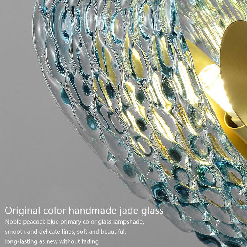 Close-up view of a chandelier's lampshade made from handmade peacock blue jade glass, featuring smooth and delicate textures with an elegant, soft appearance. The glass retains its original color and beauty, offering a long-lasting, fade-resistant finish.