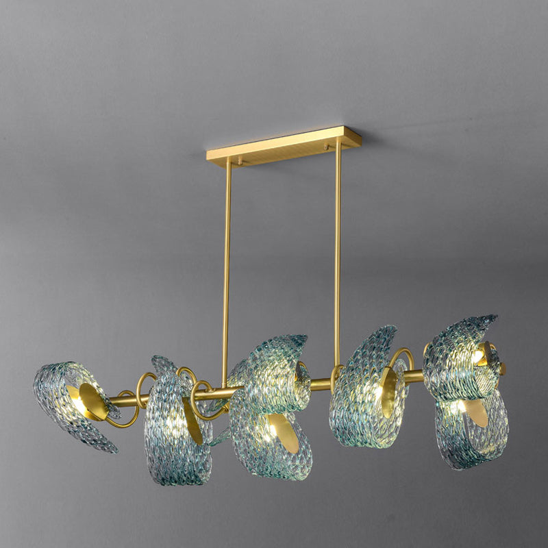 Modern chandelier with a gold frame and six swirling, translucent blue glass shades hanging from a ceiling mount against a gray background.
