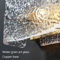 Textured glass with water-like pattern on a copper base, illuminated to showcase details.