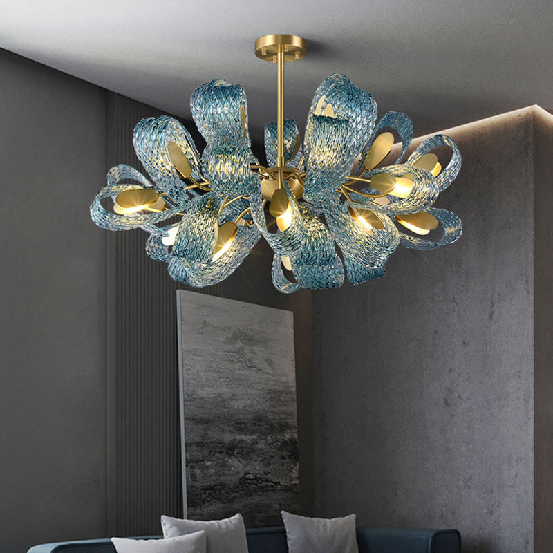 A stunning blue glass chandelier with ornate gold accents, adding a touch of elegance to any interior setting.