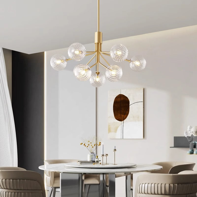 Modern spherical chandelier above a sleek living room setting.