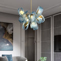 An exquisite blue glass chandelier featuring luxurious gold accents, illuminating the space with style and grace.