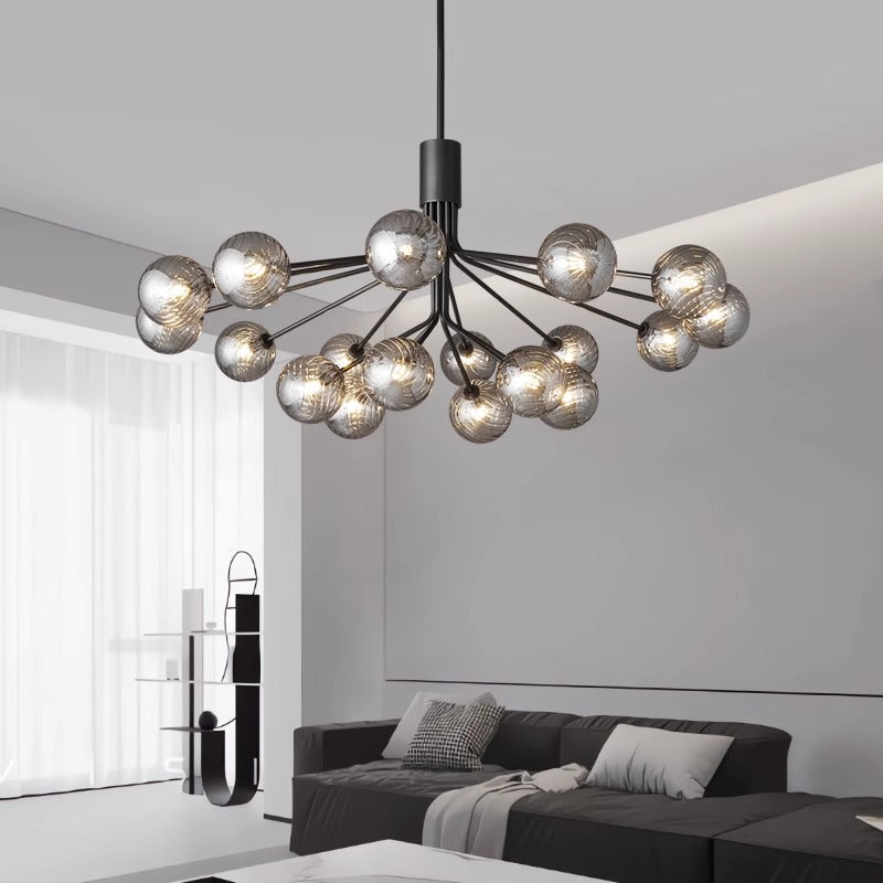 Modern spherical chandelier above a sleek living room setting.