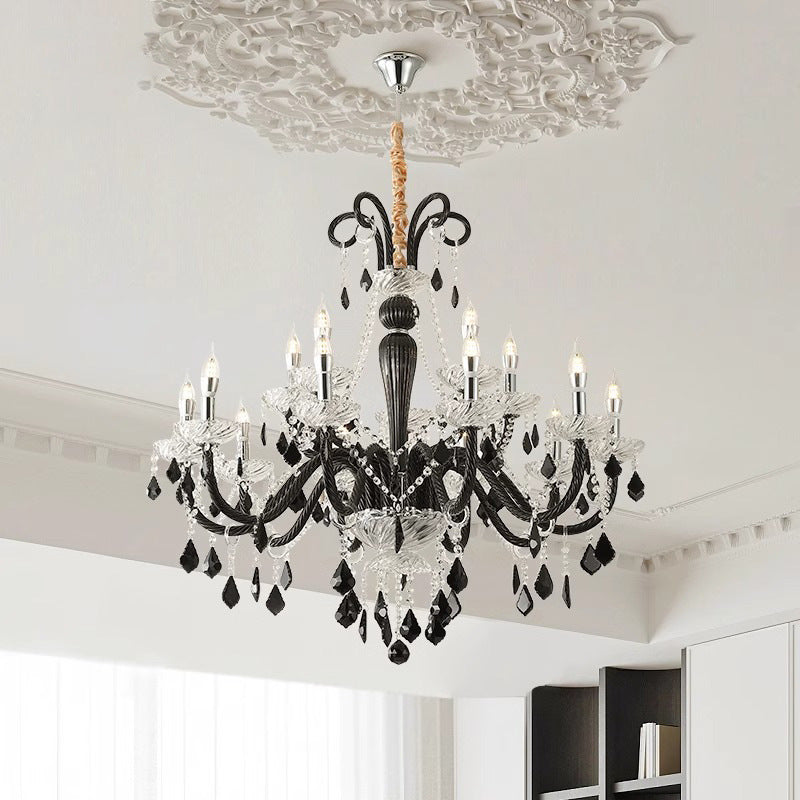 A grand chandelier hangs elegantly in a room, reflecting beautifully in a nearby mirror.