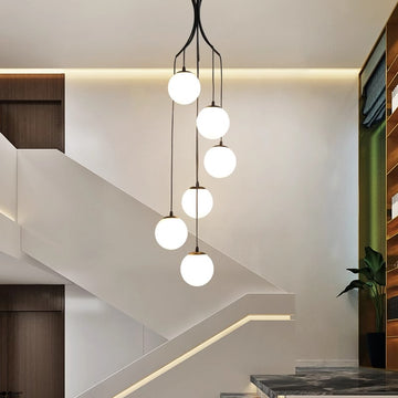 A modern chandelier featuring glass balls elegantly suspended from the ceiling, enhancing the room's contemporary aesthetic.
