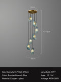 Modern bronze and peacock blue pendant light with glass shades and measurements displayed.