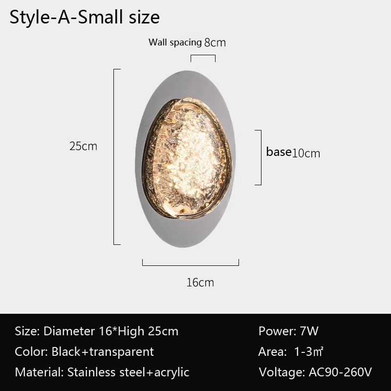 This modern acrylic wall lamp, ideal for spaces of 1-3㎡, has an oval design with a gold-textured interior and a black-transparent exterior. Featuring energy-efficient LED technology and smart dimming. Dimensions: H25 cm, base 10 cm, diameter 16 cm; voltage: AC90-260V. Product: bedroom wall lamps.