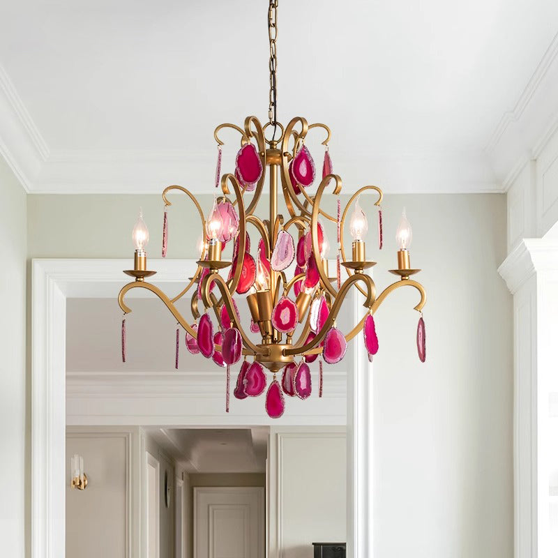 A beautiful chandelier embellished with pink stones, suspended from above, adding a touch of elegance to the room.