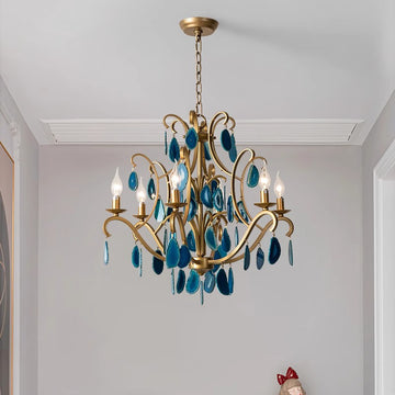 A blue chandelier elegantly suspended from the ceiling, illuminating the room with its vibrant color and design.