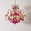 An exquisite chandelier featuring shimmering pink crystals, gracefully hanging and enhancing the ambiance of the room.