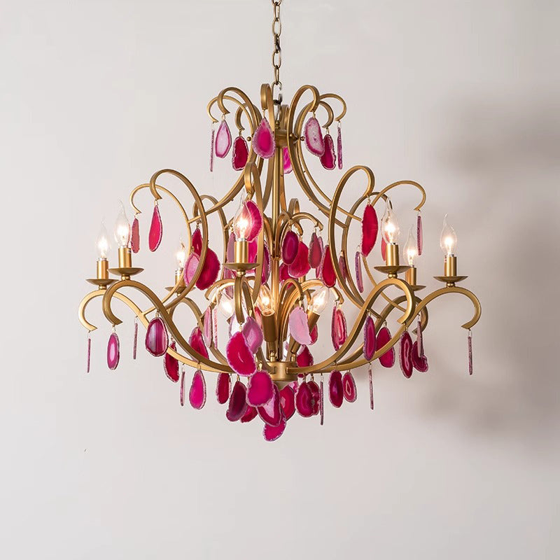 An exquisite chandelier featuring shimmering pink crystals, gracefully hanging and enhancing the ambiance of the room.