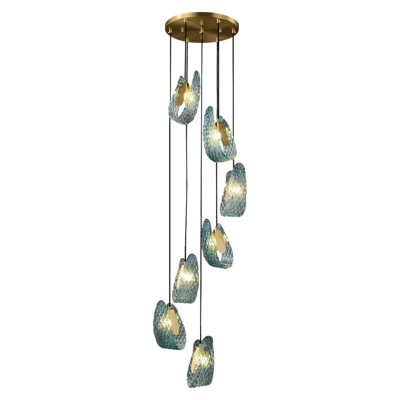 A modern chandelier with multiple hanging lights encased in textured blue shells.