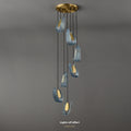 Modern pendant light with six hanging illuminated elements against a grey background.