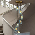 Elegant pendant lights descending along a stairwell with a modern design.