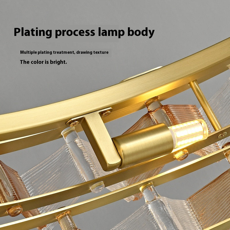 Close-up of the Chandelier Series pendant lamp showcasing a gold-plated finish, adjustable height, and an LED bulb. The image text highlights the plating process, emphasizing its bright color and texture.
