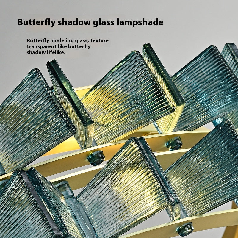 The Chandelier Series features angular glass pieces in a geometric butterfly wing pattern with textured transparent glass for beautiful light reflection. Labeled Butterfly shadow glass pendant lampshade, it boasts an adjustable height and elegant design.
