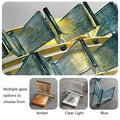 Close-up of Chandelier Series featuring decorative glass pieces in amber, clear light, and blue on a zigzag gold frame. Main image shows pendant lights; smaller images display color options—Amber, Clear Light, Blue—for this modern lighting with adjustable height.