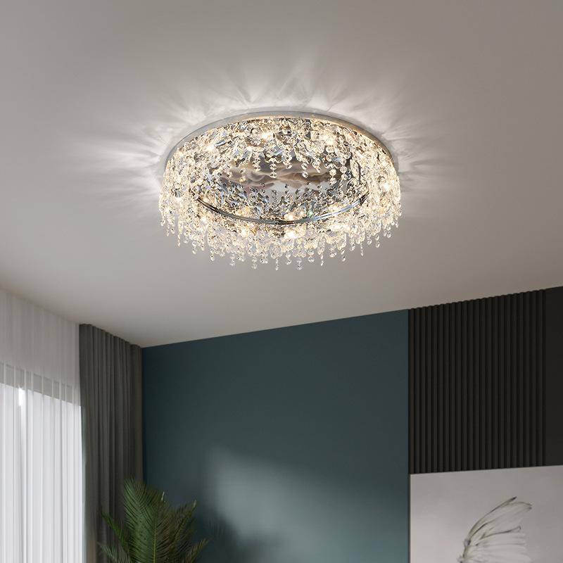 The Butterfly Crystal Ceiling Lamp features intricate detailing and LED bulbs, casting soft, radiant light in a modern room with dark walls and a window with sheer curtains on the left. Customize ambiance with its advanced DALI dimming function for an ornate touch.