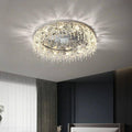 The Butterfly Crystal Ceiling Lamp hangs elegantly, its intricate design sparkling against dark walls and a large window with sheer curtains. Natural light enhances the ambiance, while an energy-efficient LED bulb adds brilliance.