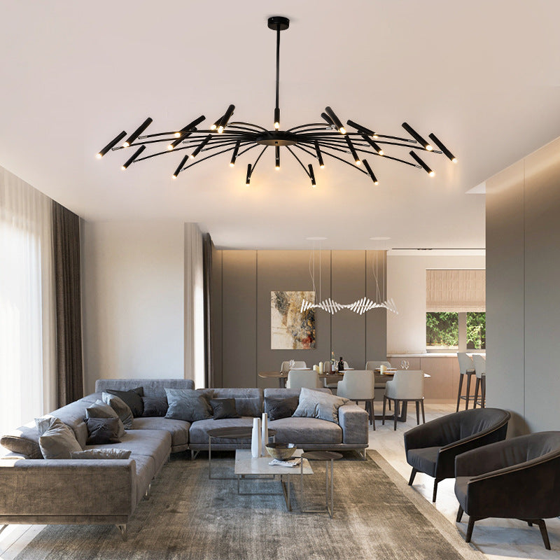 Modern living room with a large gray sectional sofa, unique ceiling light fixture, and open-plan dining area.