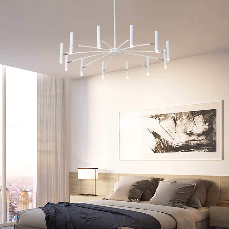 Modern bedroom interior with a stylish ceiling light fixture, framed wall art, and city view.