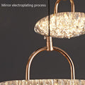 Close-up of a glowing chandelier with a textured glass shade and gold finish.