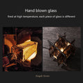 Two images showcasing hand-blown glass. Left: Crafting glass in a furnace. Right: Angular geometric design, ideal for the Vintage Brass Glass Table Lamp. Text states Hand blown glass and each piece is unique.