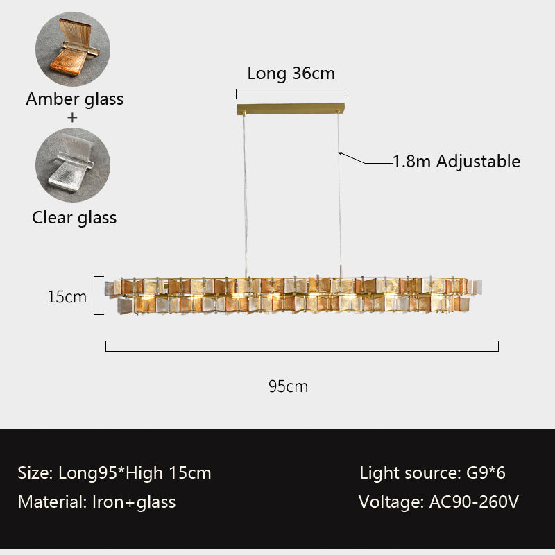 A rectangular pendant light measuring 95cm in length and 15cm in height, with an adjustable hanging wire up to 1.8 meters, perfect for installation above dining tables or kitchen islands. The fixture is crafted with a golden metal frame and a combination of amber and clear glass blocks, offering a warm and elegant glow. It features 6 G9 bulbs as the light source and supports a voltage range of AC90-260V. Made of iron and glass, this pendant light is an excellent choice for dining areas and kitchen spaces.