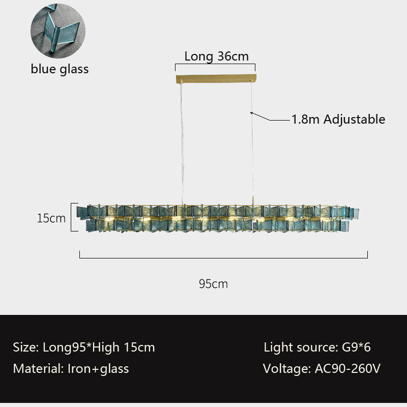The Chandelier Series offers a sleek rectangular glass pendant light with a blue design, measuring 95cm by 15cm. It hangs from a 36cm gold fixture with adjustable wires up to 1.8m, supports six G9 bulbs, and operates at 90-260V for modern elegance.