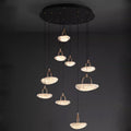 Modern pendant lights with glowing crystals suspended from a dark ceiling.
