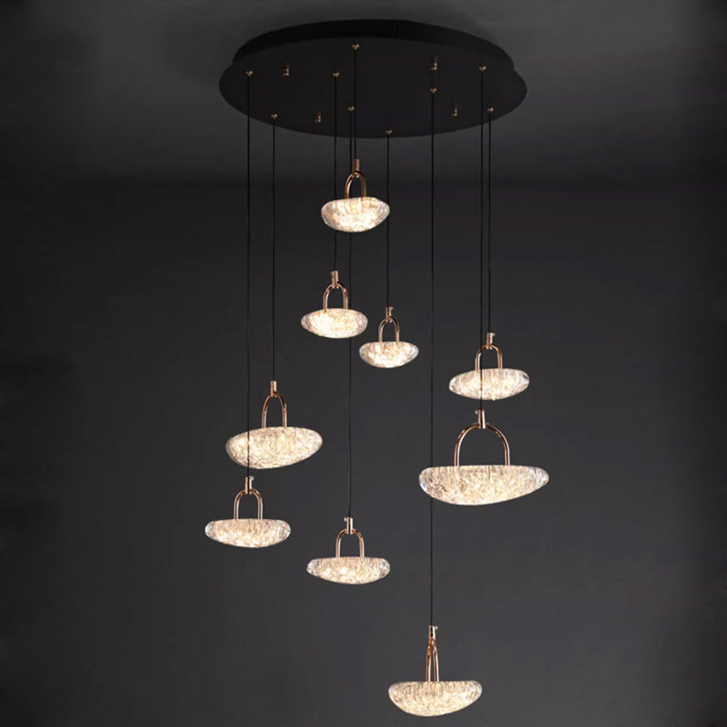 Modern pendant lights with glowing crystals suspended from a dark ceiling.