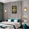 A modern bedroom showcases a large bed with teal and light gray pillows, flanked by two Metal Boat-Shaped Wall Lights and centered by fringe art. Teal curtains and a matching chair bring color against neutral walls and furniture for a sleek appearance.