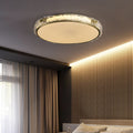 Modern ceiling light fixture in a cozy bedroom with elegant decor.