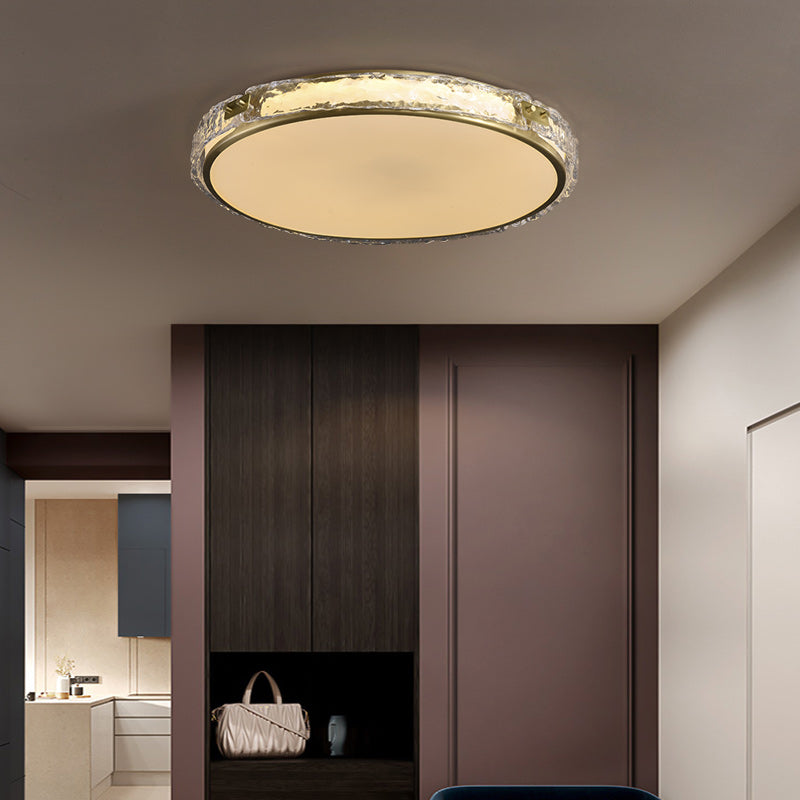 Modern ceiling light fixture in a room with dark wooden paneling and a glimpse of a kitchen.