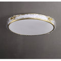 Oval ceiling light fixture with a gold rim and textured glass against a gray background.