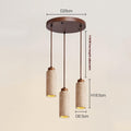 A Travertine Restaurant Chandelier features three cylindrical pendant lights with wood-textured finishes suspended from a D25cm circular wooden ceiling mount. Each light measures H18.5cm and D6.5cm, with a maximum adjustable length of 170cm for added versatility.