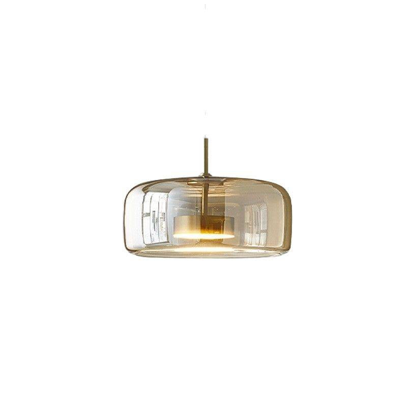 The Retro Chandelier, a modern minimalist light with a clear glass shade, hangs elegantly from an adjustable wire against a white background. Its warm white glow softly illuminates the space, reflecting beautifully off the curved glass surface.