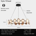 The round chandelier is a stylish, modern lighting pendant with 16 oval heads in black and French gold, crafted from iron and acrylic. It features a remote-controlled smart dimming function, adjustable height, and provides 128W of power for spaces sized 15-25㎡.