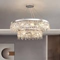 The Crystal Butterfly Chandelier features two circular tiers adorned with sparkling K9 crystal droplets and a modern metal frame, offering a warm glow as it luxuriously hangs from the ceiling.