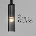 A sleek mirror glass pendant light hanging elegantly, reflecting ambient light and enhancing the room's modern decor.