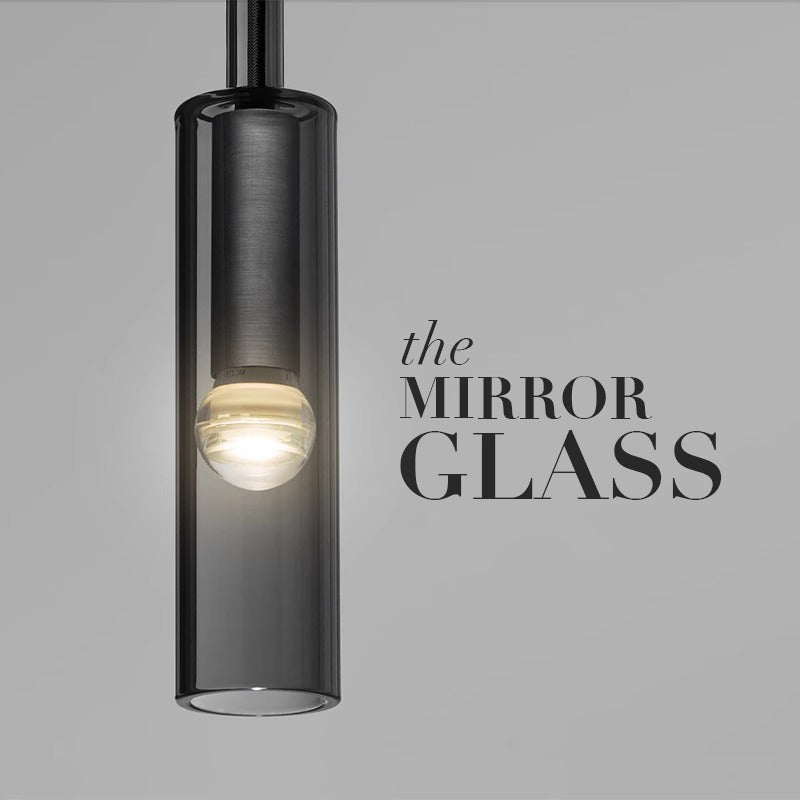 A sleek mirror glass pendant light hanging elegantly, reflecting ambient light and enhancing the room's modern decor.