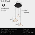A 3-headed pendant light with remote control, black and gold colors, iron and acrylic materials, and adjustable height.