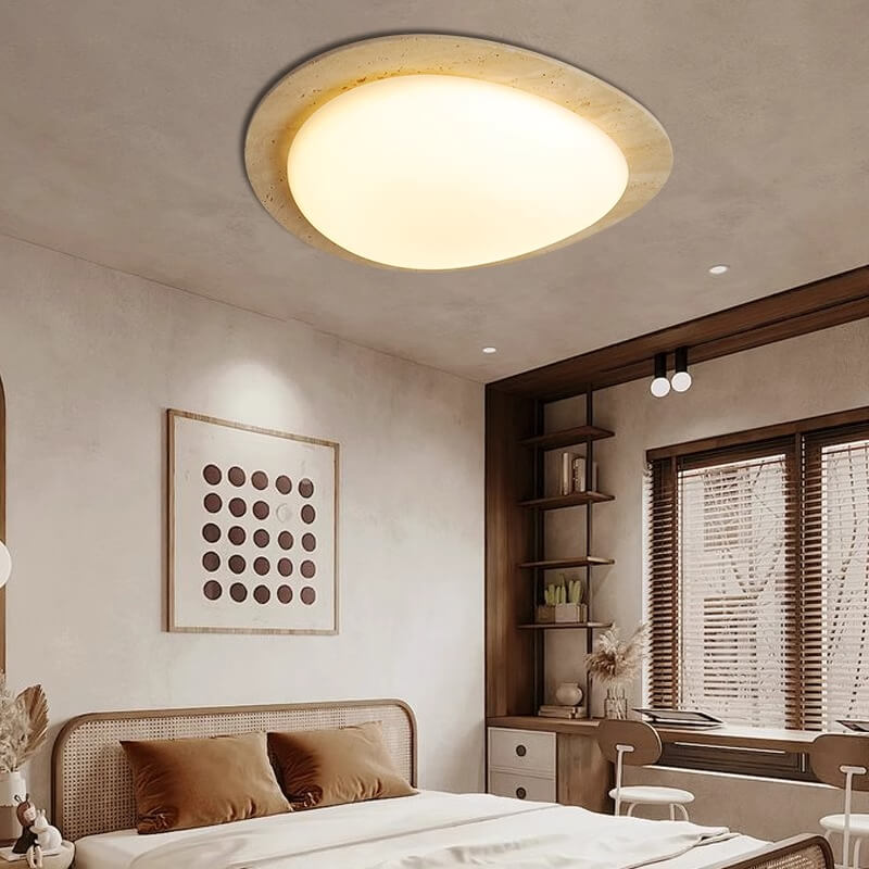 The Wabi-Sabi Travertine LED Ceiling Light features an oval soft-glow white diffuser with a travertine-inspired border, reflecting a subtle Wabi-Sabi aesthetic for modern interiors.