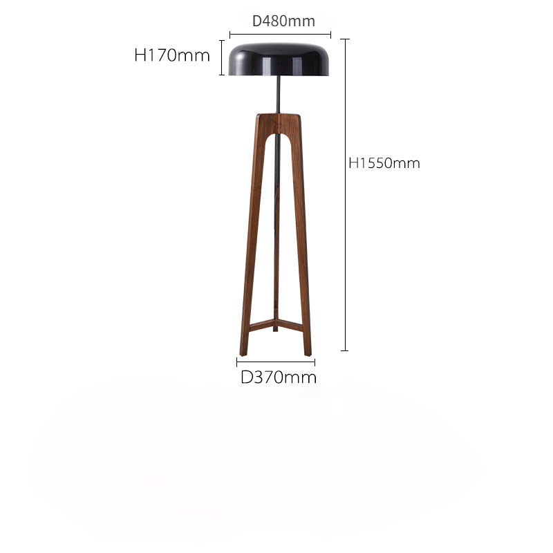 The Tripod Floor Lamp, featuring a wooden base and black dome-shaped shade, offers a contemporary feel. It stands 1550mm tall with a shade diameter of 480mm, base diameter of 370mm, and shade height of 170mm. Compatible with LED bulbs for improved efficiency.