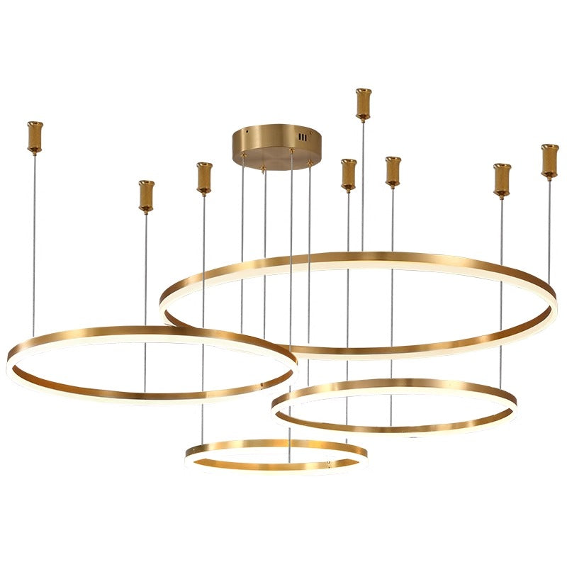 Modern gold pendant light with three circular rings suspended at different heights.