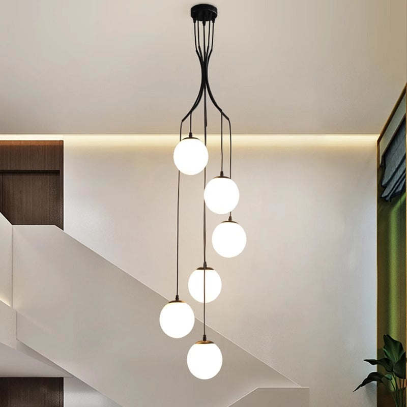 Contemporary chandelier adorned with glass balls, gracefully hanging from the ceiling, adding sophistication to the space.