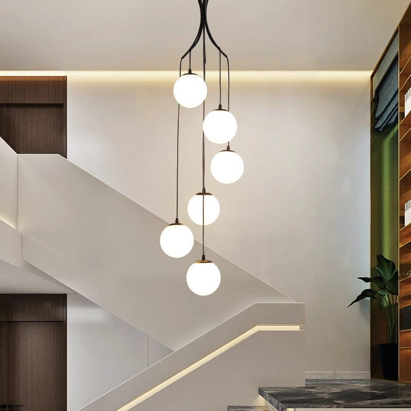 A modern chandelier featuring glass balls elegantly suspended from the ceiling, enhancing the room's contemporary aesthetic.