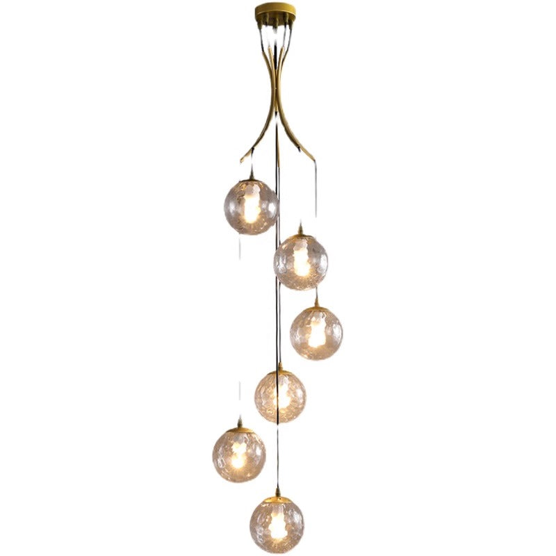 Elegant chandelier composed of glass balls, hanging from the ceiling, exemplifying modern design and sophistication.